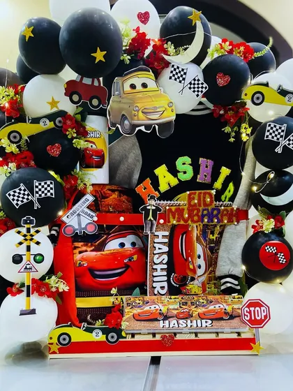 An exquisite bloom and balloon hamper for Eid. This one has a 'Cars' theme and is filled with personalised goodies for 'Hashir'.