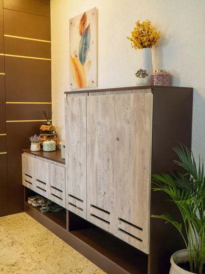 Foyer Problem Solving: The client had an unsightly duct door at their entrance. My solution was to design custom paneling and a shoe rack that completely conceals it. This before-and-after demonstrates how I solve practical problems with elegant design.