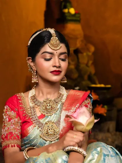 A quiet, contemplative moment. The makeup enhances her natural beauty, giving her a divine and graceful aura for her bridal portraits.