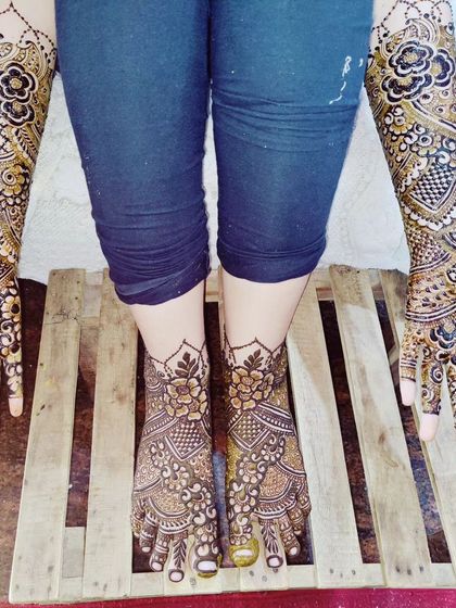 The full bridal package, with detailed henna on both arms and feet. This ensures the bride looks perfect from head to toe for all her wedding functions.