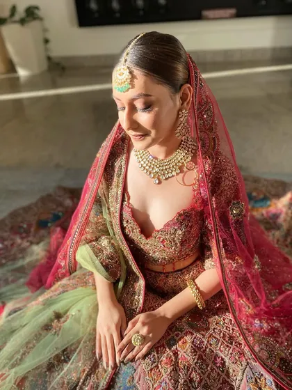 A sun-kissed moment that makes the bridal glow look truly ethereal. The natural light enhances the radiant finish of the makeup and the rich colors of the lehenga, creating a breathtaking image.