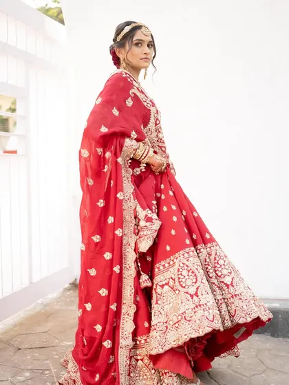 The full look for Jagruti's wedding day. Dressed in a magnificent red lehenga, her makeup was designed to be elegant and timeless.