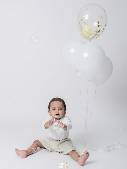 A joyful moment with balloons and bubbles, part of our fun-filled first birthday sessions.
