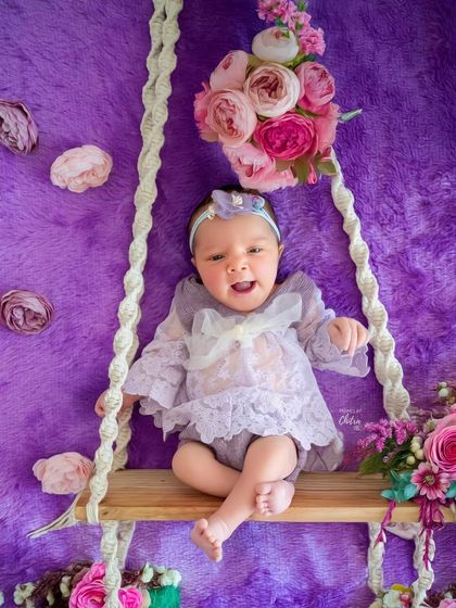 A moment of pure joy and a big, happy expression from this little one on her floral swing. It's wonderful to capture babies when they are awake and expressive too.