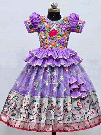 A closer view of the lavender floral lehenga. This angle shows the intricate details of the embroidery on the blouse and the delicate ruffles on the peplum top.