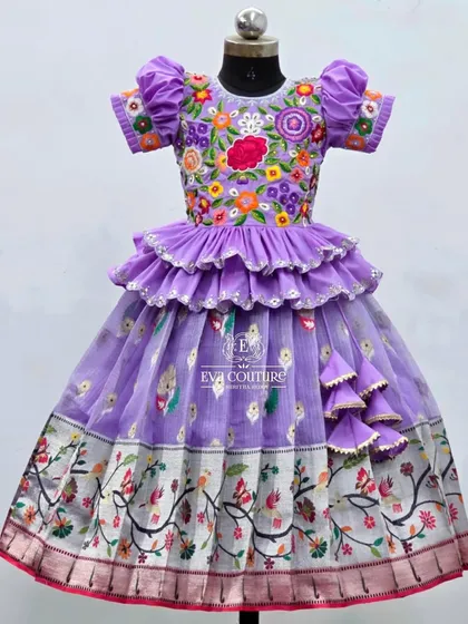 A closer view of the lavender floral lehenga. This angle shows the intricate details of the embroidery on the blouse and the delicate ruffles on the peplum top.