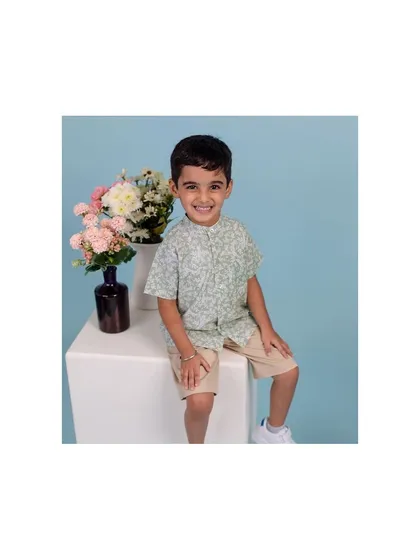 This young man’s bright smile made this studio session an absolute delight. We used a clean, simple backdrop with a pop of color from the flowers to keep the focus on his happy and charming personality.