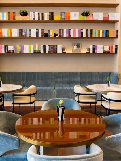 We believe in creating spaces that feel curated and personal. The combination of banquette seating, plush armchairs, and well-stocked bookshelves in the clubhouse restaurant creates a cozy, library-like atmosphere that encourages guests to linger.