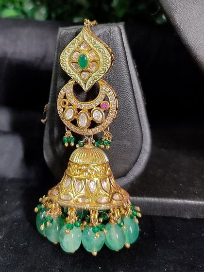 A beautiful passa with a temple-style jhumka drop and green beads.