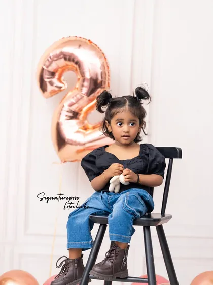 Sometimes, the simplest moments are the most precious. This clean, modern studio portrait celebrates a second birthday with minimalist props. The focus remains entirely on the child's curious expression, showcasing how I capture personality even in a simple setup.