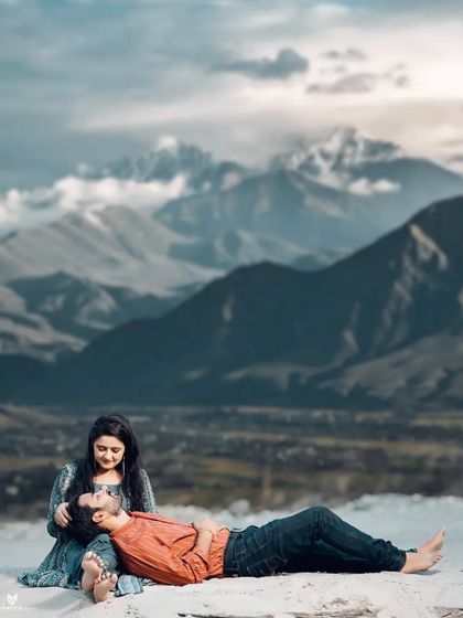 A beautiful composite image with a couple relaxing in a stunning mountain landscape, perfect for an album cover.