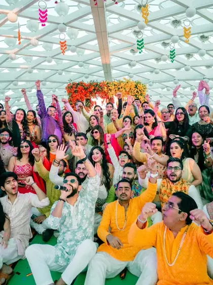 This is what it looks like when a wedding turns into a full-blown concert. My goal is to get every single person, from the youngest cousin to the oldest uncle, feeling the energy and celebrating together. This picture captures that collective joy perfectly.