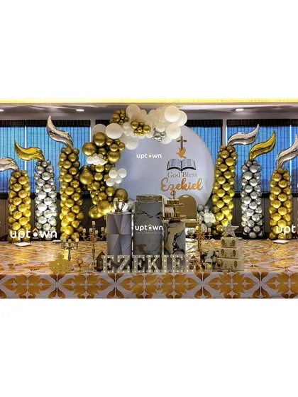 I design elegant and meaningful setups for religious milestones like this Baptism. The decor uses a gold and white color scheme with symbolic elements like candle-shaped balloon pillars and a custom backdrop to honor the special occasion.