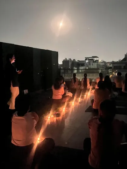 The silhouette of our group meditating under the full moon. This image captures the profound stillness and collective energy that we cultivate in our sacred ceremonies.