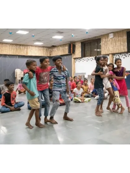 A beautiful, candid moment of friendship and fun. A group of boys from the workshop, arms around each other, sharing a laugh after a dance session.
