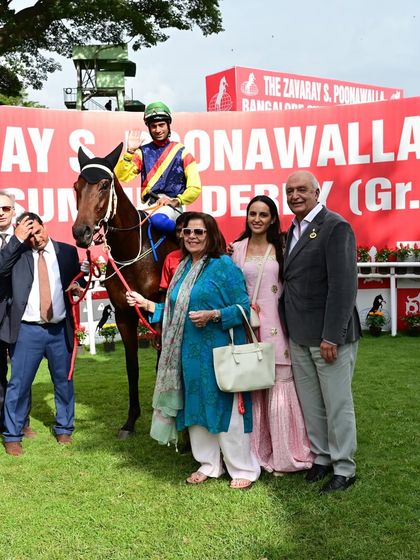 Fynbos, the winner of The Zavaray S. Poonawalla Bangalore Summer Derby GR I, with jockey P. Trevor and the ecstatic owners.