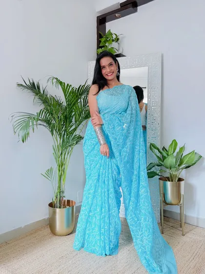 A full look at this beautiful sky blue Chikankari saree. The intricate white thread embroidery on the georgette fabric is a classic style that is always elegant.
