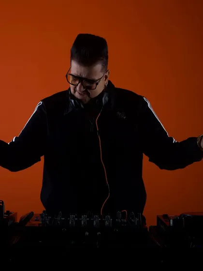 A silhouette shot against a bold orange background. This artistic photo captures the mood and atmosphere I create with my music.