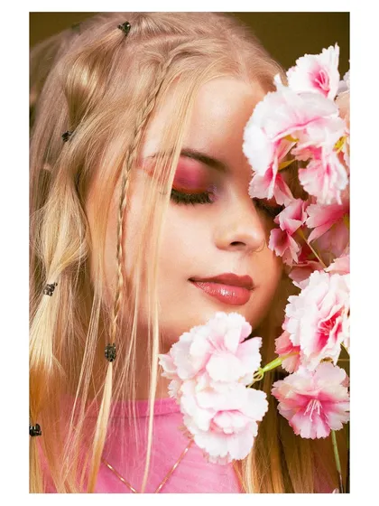 Another shot from the floral hair series, with the model's eyes closed and flowers framing her face.