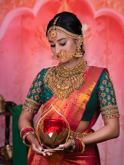 A serene shot of the model, holding a diya. This look is perfect for a Muhurtham ceremony.