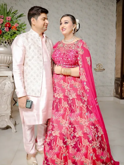 A sweet moment between a couple at their engagement. The coordinating pink outfits and their happy expressions make this a lovely, candid-style portrait.