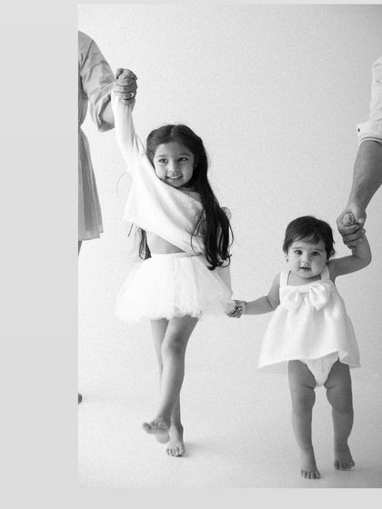 Two sisters, holding hands and hearts. Capturing the bond between siblings is one of my favorite parts of a family session, preserving their shared childhood.
