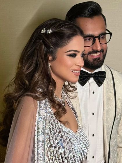 The final look: a happy couple, with the bride wearing a simple twisted half-up style with sparkling clips.