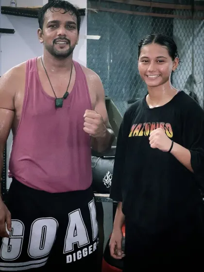 A post-workout photo with one of my dedicated female fighters. The sweat and hard work build a strong team bond.