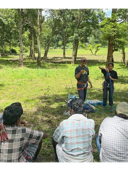 Our instructors demonstrating modern rope skills and safety equipment to a group of honey harvesters. The goal is to offer a safety buffer without interfering with their traditional methods.