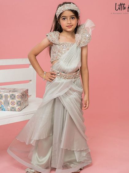 A full length shot of the Aditi Drape Saree, showing the elegant layers and embellished belt.