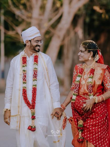 The couple walking hand-in-hand, sharing a happy and loving glance after their wedding ceremony.