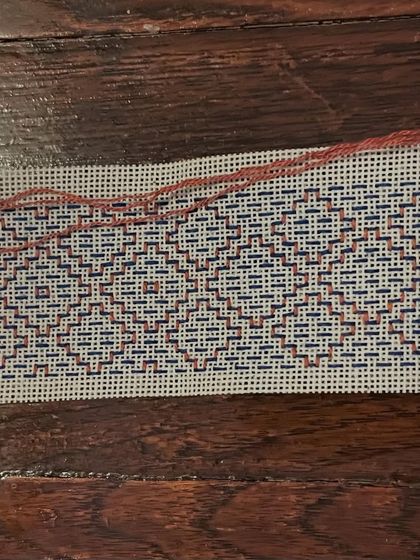 A work-in-progress view of a Kasuti border. This shows how the same stitch can be used with different colors and variations to create diverse visual effects, perfect for sarees, blouses, or home decor.