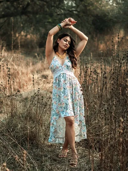 This dynamic pose with arms raised adds energy and movement to the portrait. It breaks from static poses and creates a feeling of freedom and expression, which is perfect for a bohemian-themed fashion story.