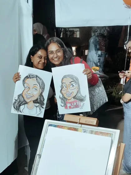 Friends having a great time at a carnival event. They were so excited to get their caricatures done together, and each left with a personal, funny portrait to remember the day.
