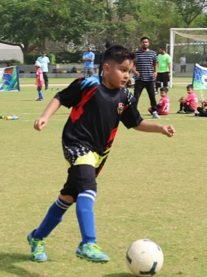 A young player dribbles with confidence during a DFA League match. Our league provides the perfect platform for players to develop their skills in a competitive setting.