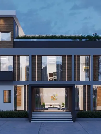 An office building designed with a clean, modern aesthetic, featuring large windows for ample natural light. A rooftop terrace with greenery provides an outdoor space for employees.