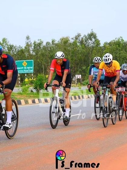 The elite peloton, a colorful and dynamic sight, races down the highway.