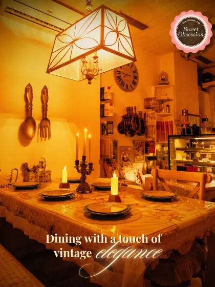 This dining table is set for an evening of vintage elegance. The candelabra, lace tablecloth, and warm lighting are all part of the experience, making you feel like you're dining in a private French home.