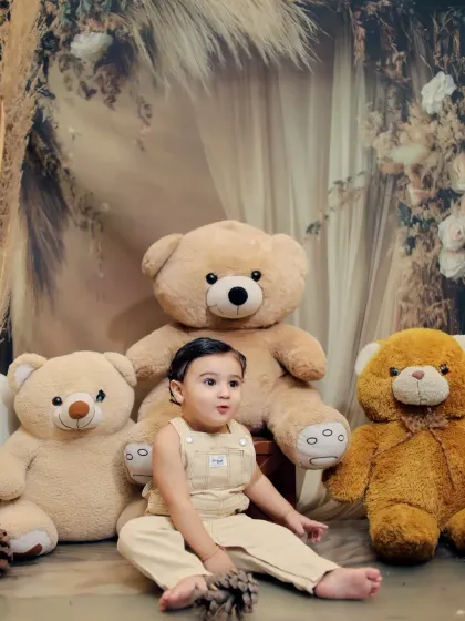 A cozy studio session surrounded by cuddly teddy bears. The neutral tones and soft textures create a warm and inviting atmosphere for adorable baby photos.