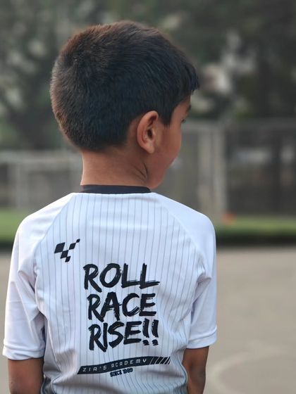 A closer look at the "Roll Race Rise" motto on our academy bodysuit. It's a reminder of what we train for every day.