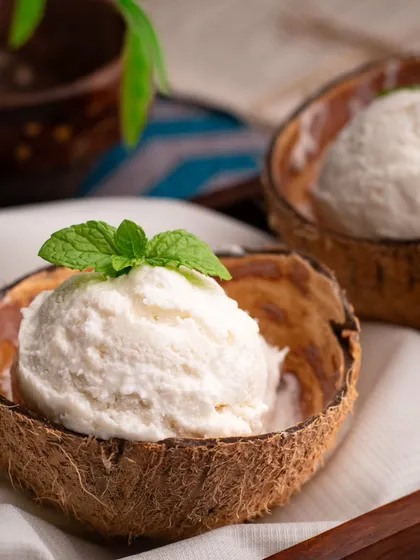 A closer look at our coconut ice cream shot, highlighting the creamy texture and fresh mint garnish.