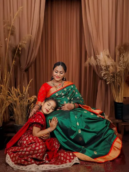 The quiet and tender bond between a mother and daughter, captured in our studio. Dressed in beautiful traditional sarees, this portrait highlights heritage and love against a warm, elegant backdrop.