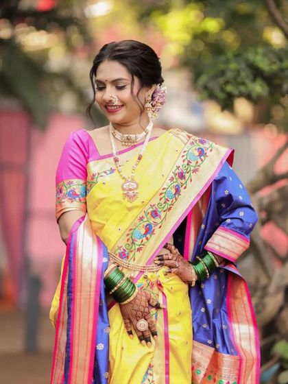 A beautiful Maharashtrian bride in her vibrant Paithani saree. I created a soft, textured updo and adorned it with flowers to match her colorful attire.