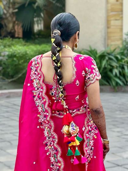 Another shot of the gota patti braid, showcasing its length and the beautiful way it complements the bride's embroidered outfit.