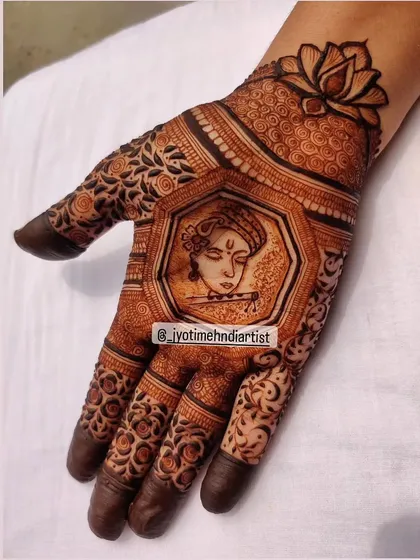 I design mehndi for all religious festivals and occasions. This piece features a portrait of Lord Krishna playing the flute, framed by intricate patterns and topped with a lotus, perfect for Janmashtami or any spiritual celebration.