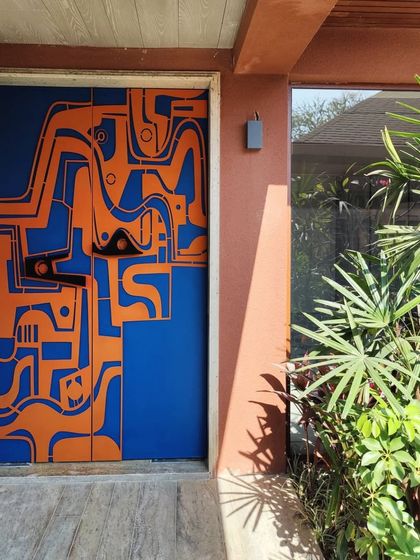 The full view of the artistic entryway, where the door becomes the focal point of the home's facade. The design was conceived to be a piece of art you interact with daily.