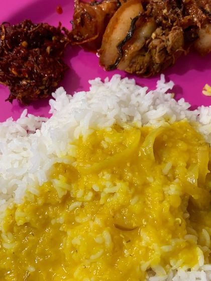 The simple yellow dal and white rice are the perfect base for the flavourful pork and spicy red chilli chutney.