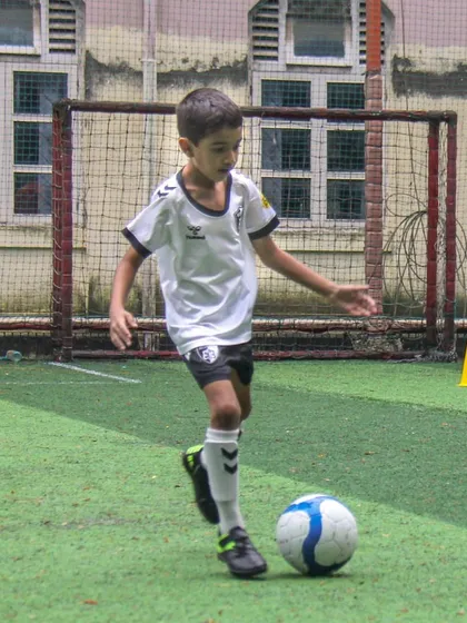 This player navigates a cone drill, a simple yet effective exercise for improving dribbling and control under various conditions.
