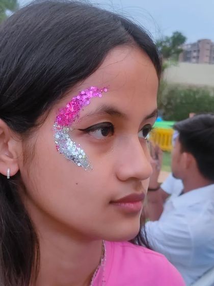 A bold sweep of pink and silver glitter across the eye, a perfect party look.