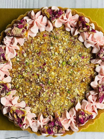 A unique fusion dessert, this is my Rose Chikki Cheesecake Tart. It combines the crunchy, floral flavor of rose chikki with the creamy texture of cheesecake in a buttery tart shell.